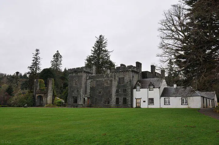 Armadale Castle's stone ruins beside white gabled buildings