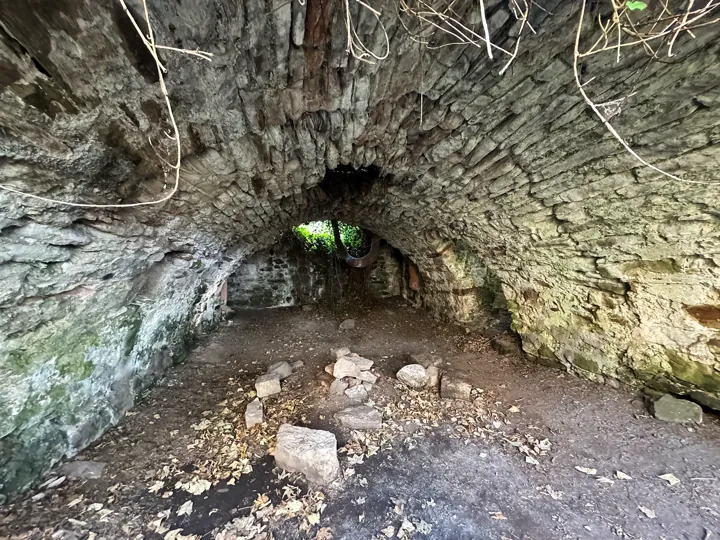 Auldhame Castle's vaulted stone chamber with loose stones on the floor