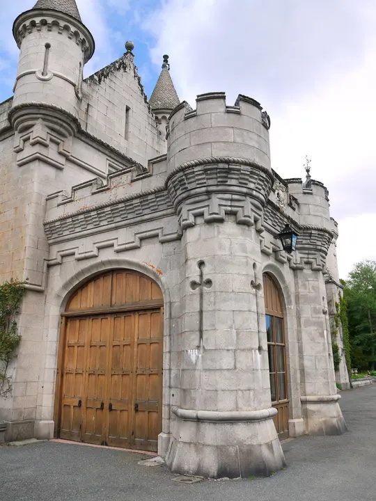 Balmoral Castle arched wooden gateway beneath projecting stone turrets