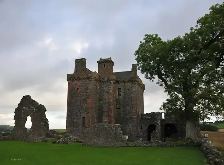 Balvaird Castle tower and ruined walls beneath a cloudy sky