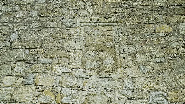 Blocked rectangular opening with a stone surround in Barr Castle's wall.