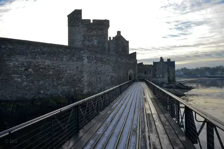 Wooden walkway beside the waterfront walls of Blackness Castle