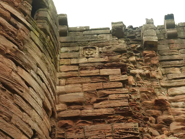 Close view of sandstone blocks and projecting stone supports at Bothwell Castle