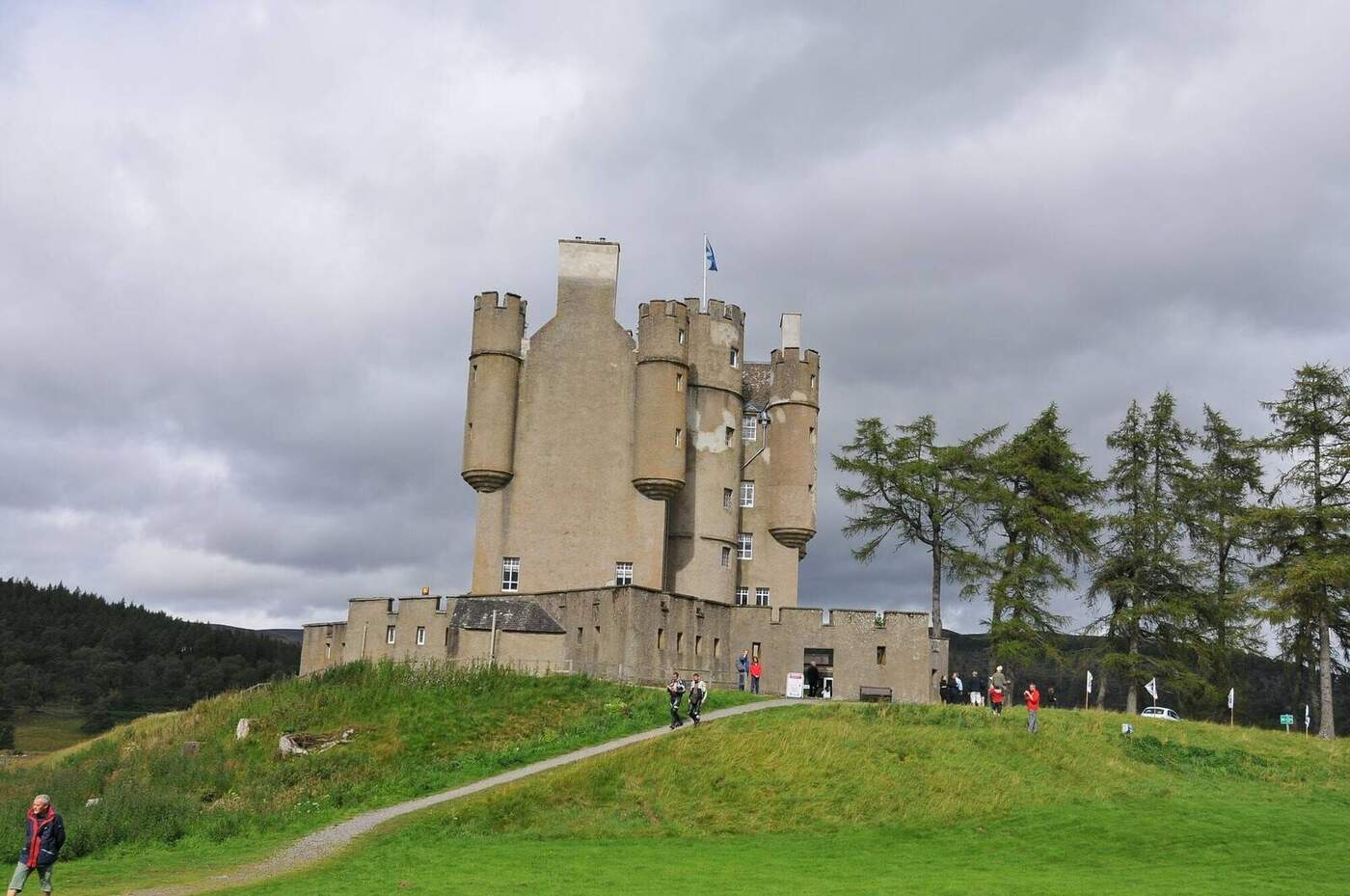 Braemar Castle with round turrets above a grassy slope