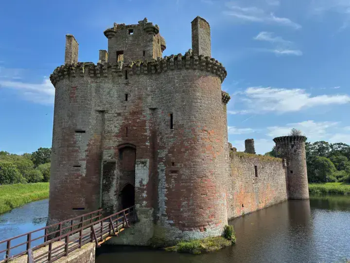Wooden bridge leading to the twin-towered entrance of Caerlaverock Castle