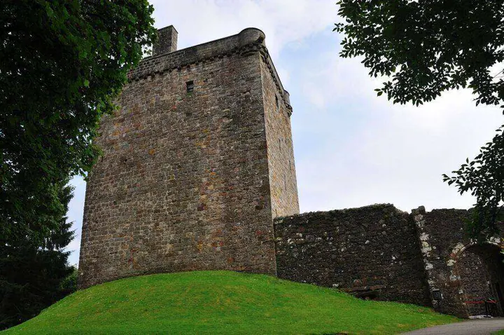 Tall stone tower of Castle Campbell viewed from the lawn