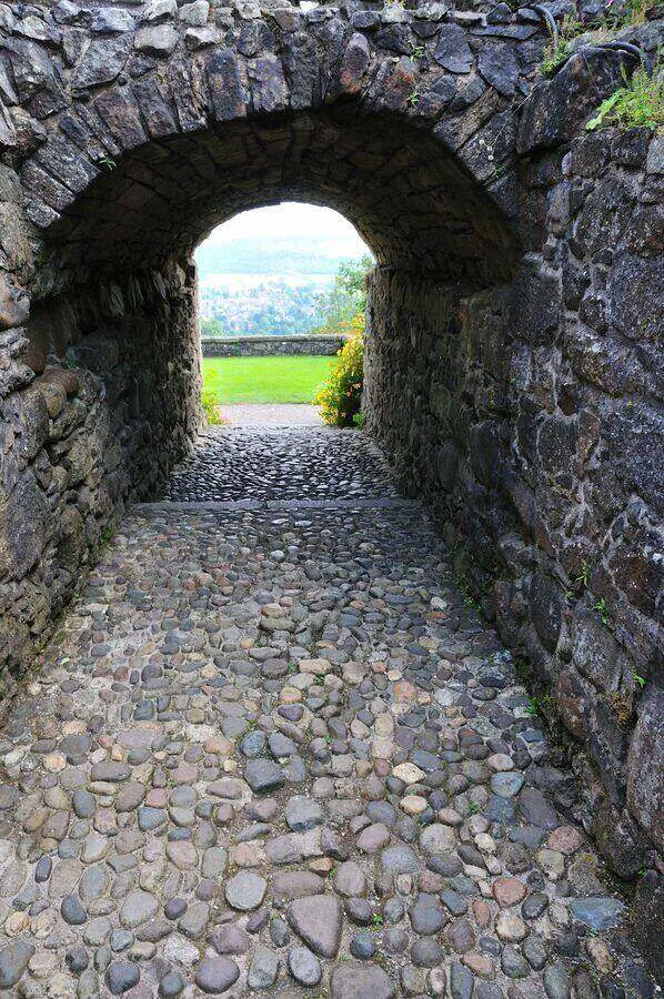 Cobblestone passage beneath a stone arch at Castle Campbell