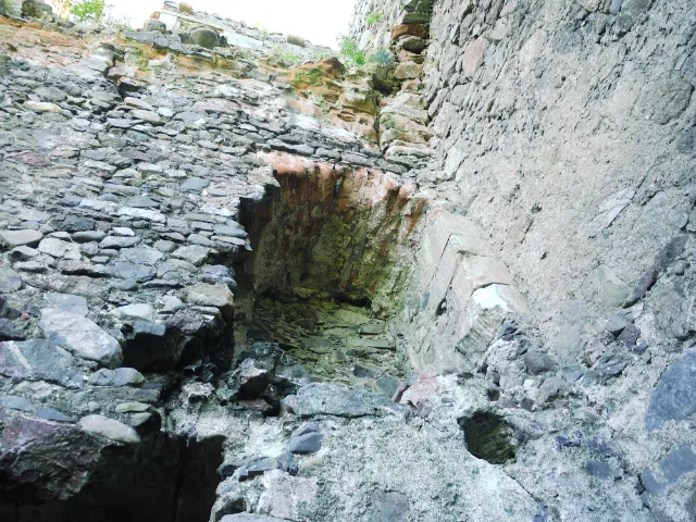 Rough stone interior wall with a recessed opening at Carleton Castle