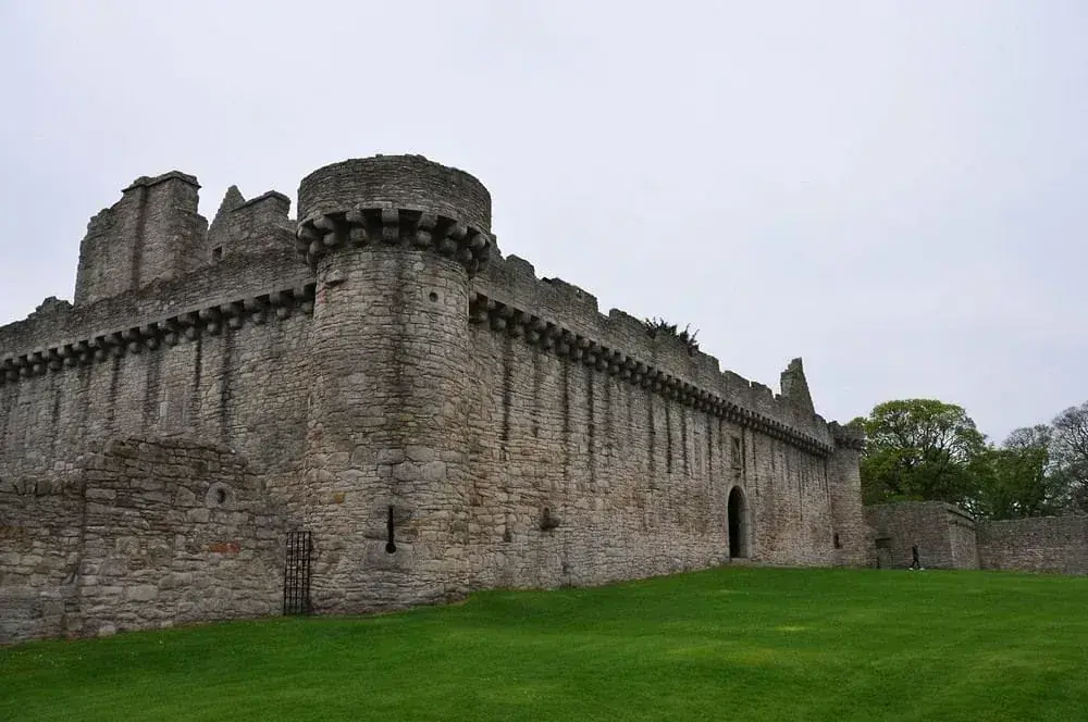 Craigmillar Castle corner tower and tall walls beside the lawn