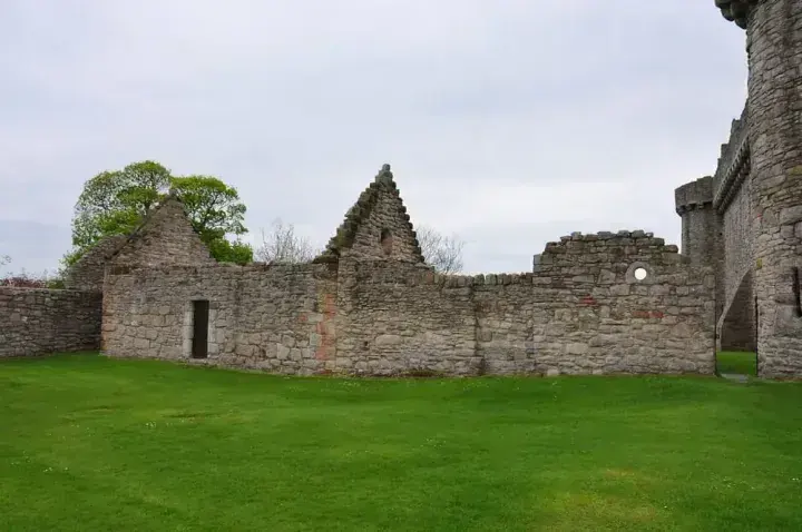 Roofless gables beside the green lawn at Craigmillar Castle