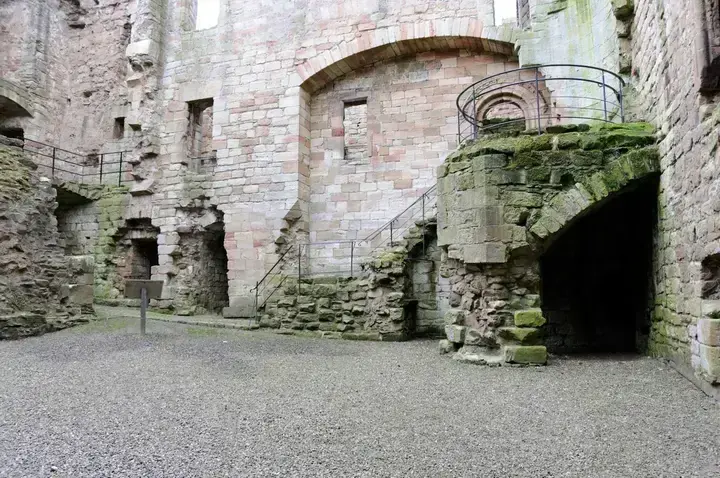 Stone staircase and archways in Crichton Castle courtyard