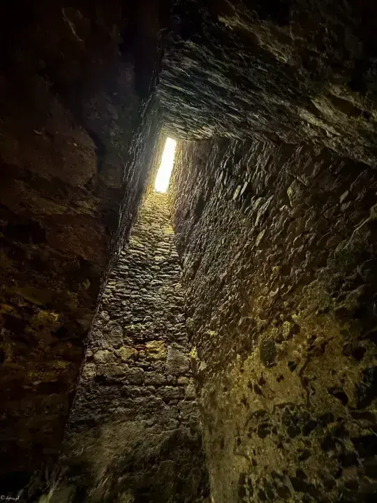 Daylight through a narrow opening in Dirleton Castle's thick stone walls