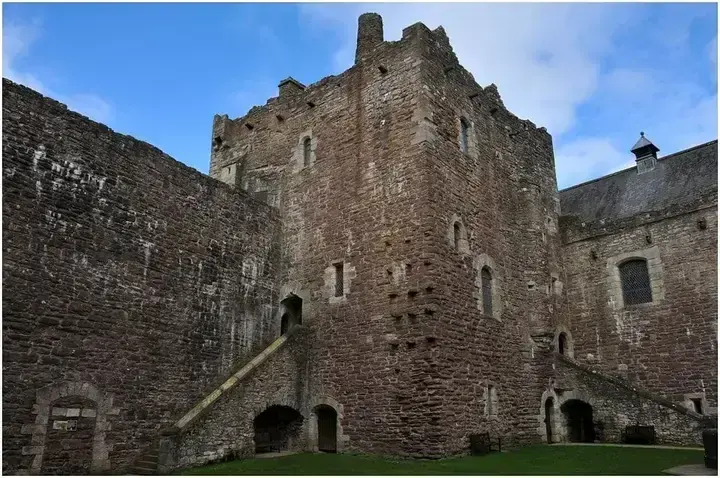 Tall courtyard tower with exterior stone stairs at Doune Castle
