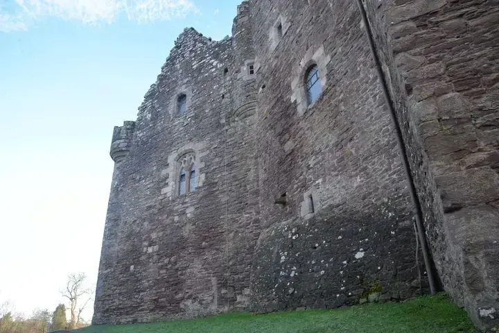 Doune Castle's stone facade and paired windows seen from below