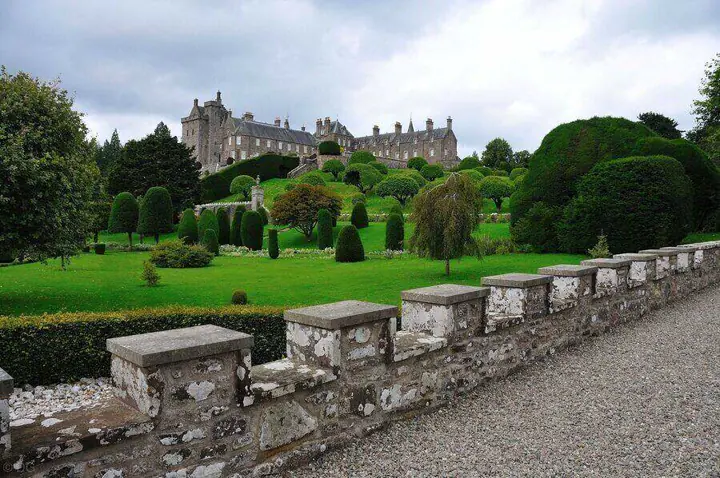 Stone balustrade beside shaped trees in Drummond Castle gardens