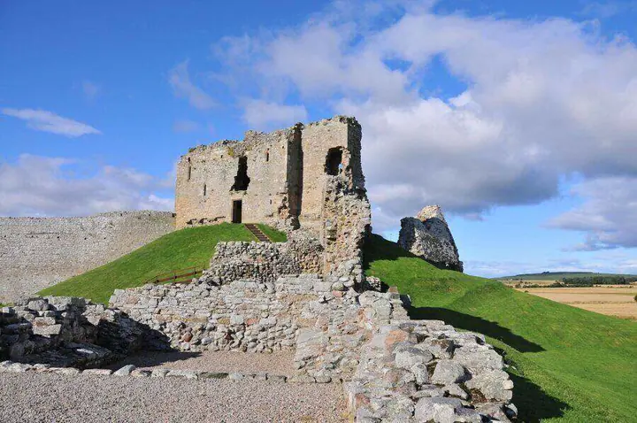 Broken walls leading towards the tower ruins at Duffus Castle