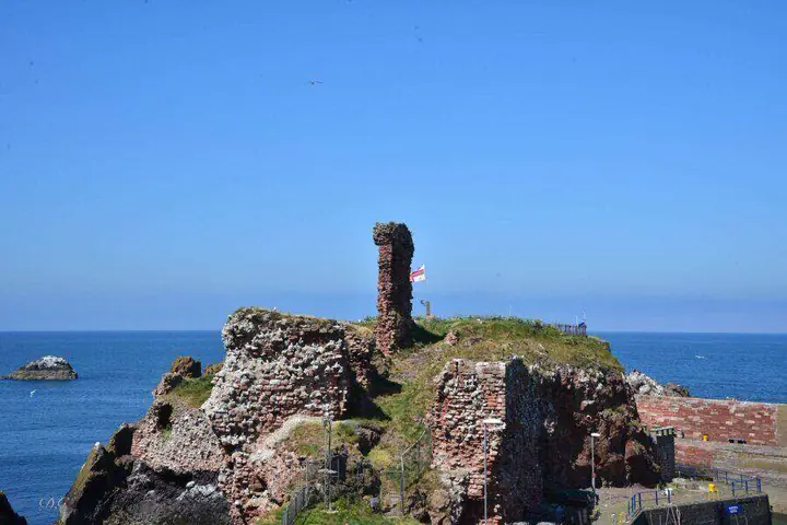 Dunbar Castle ruins with a narrow standing wall against the sea