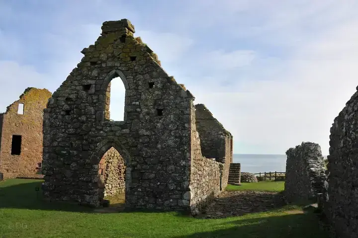 Ruined gable with pointed doorway and window at Dunnottar Castle