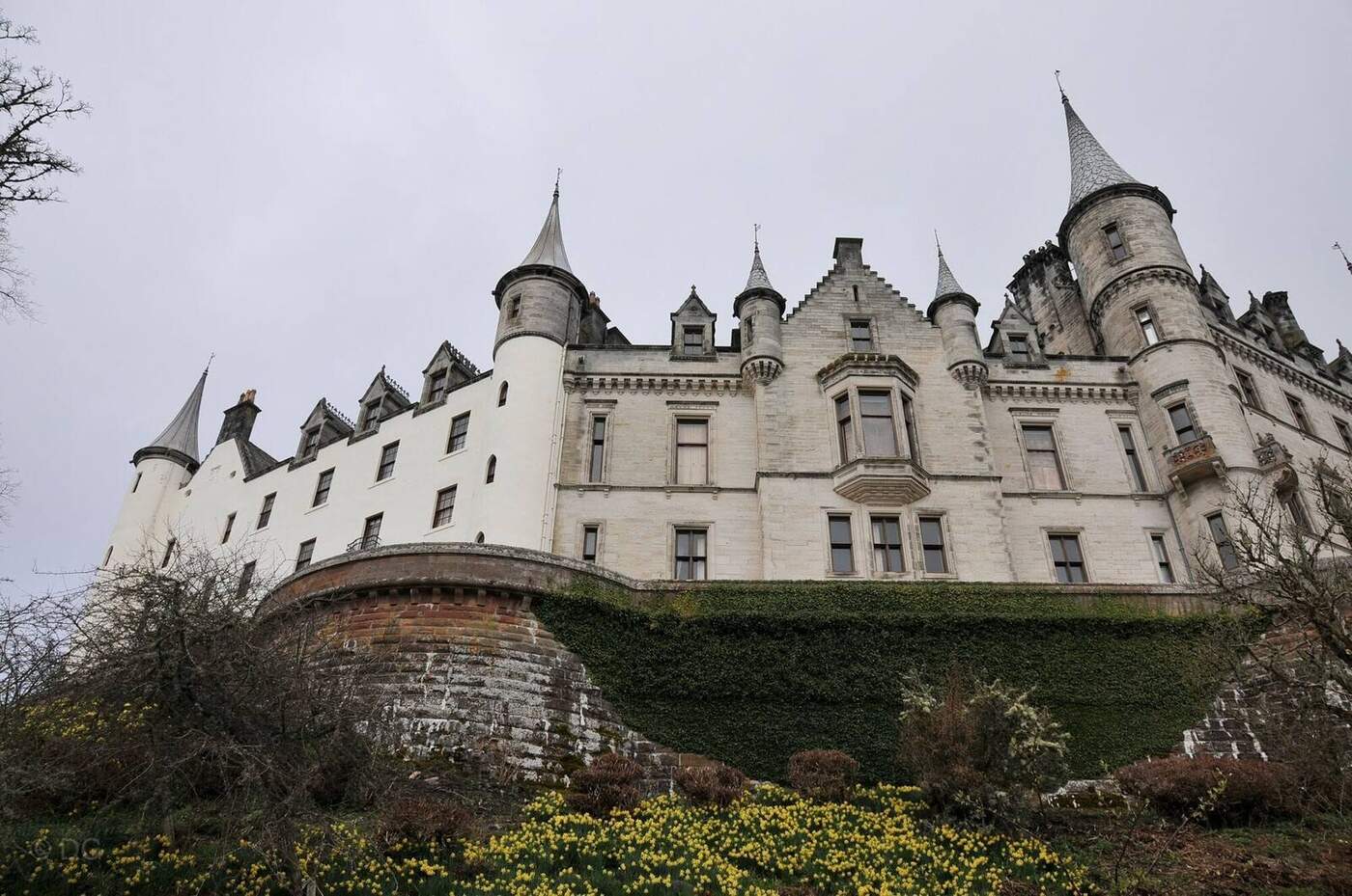 Dunrobin Castle pale walls and pointed turrets above a terraced slope