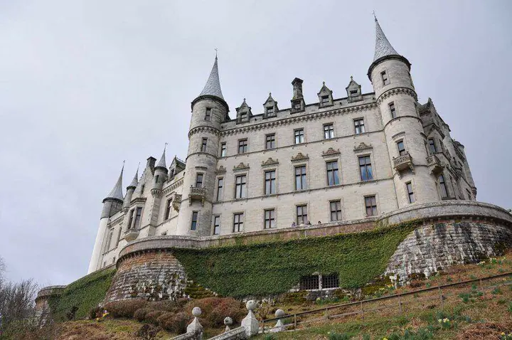 Dunrobin Castle façade with round turrets above stone terraces