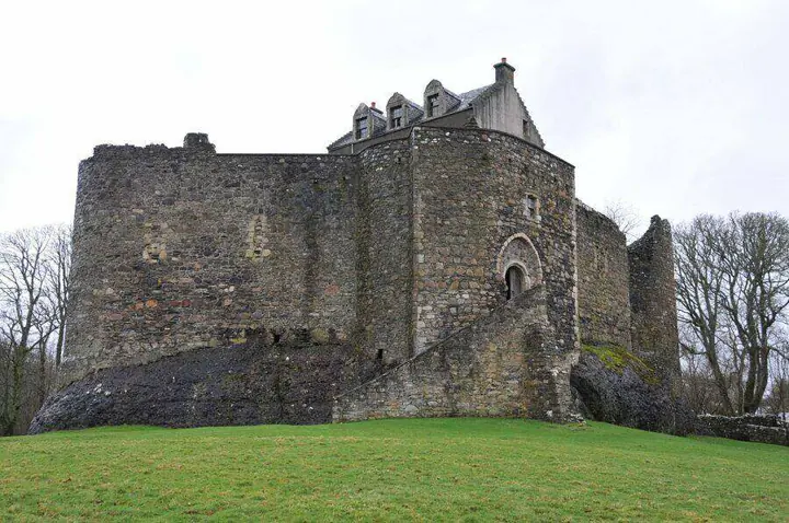 Dunstaffnage Castle tower and curtain walls viewed across the lawn