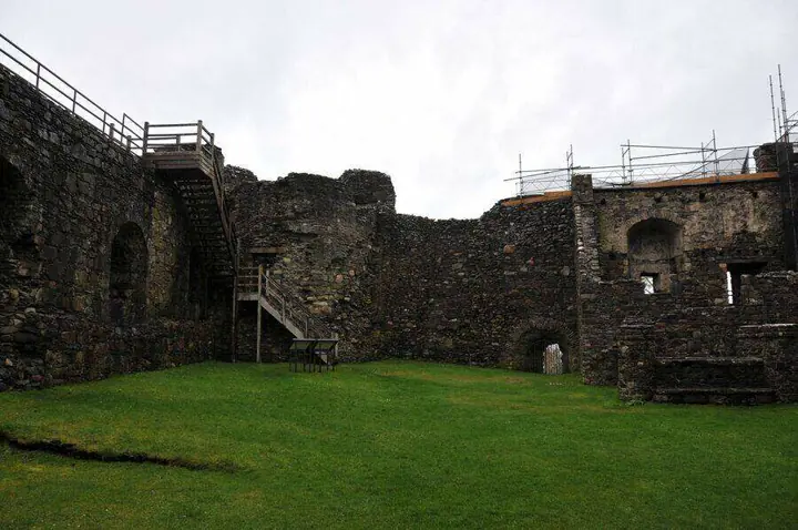 Grassy courtyard and wooden wall-walk stairs at Dunstaffnage Castle