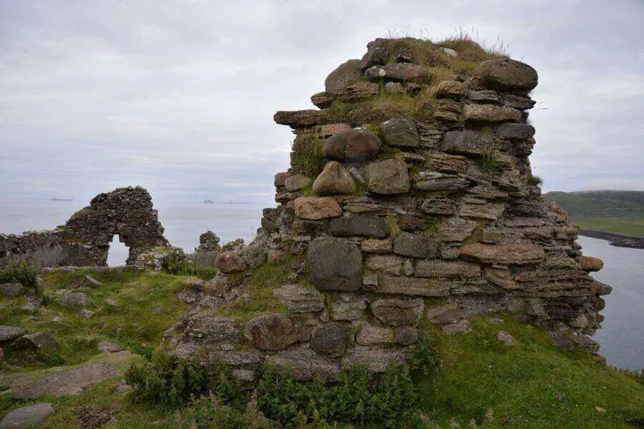 Rough stone wall remnant at Duntulm Castle with the sea behind