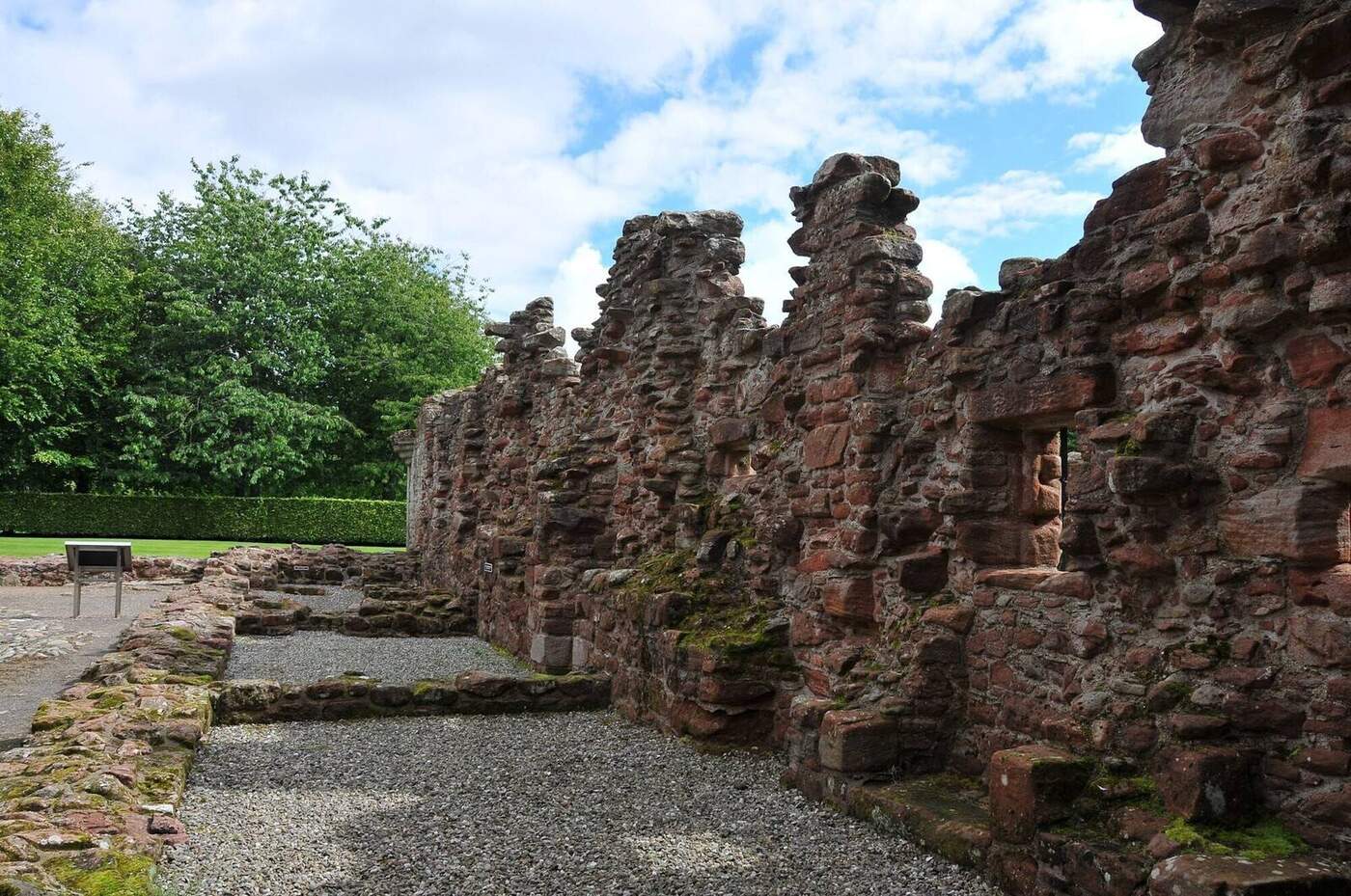 Roofless stone walls beside the gravel courtyard at Edzell Castle