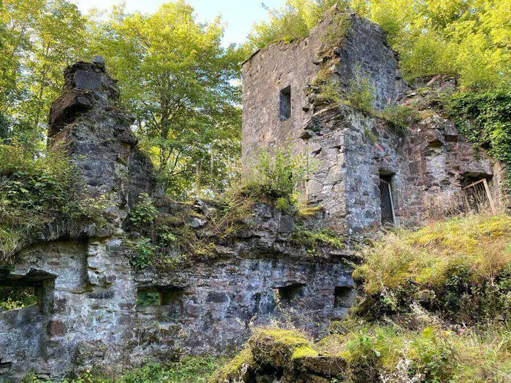 Overgrown lower walls beneath the ruins of Finlarig Castle
