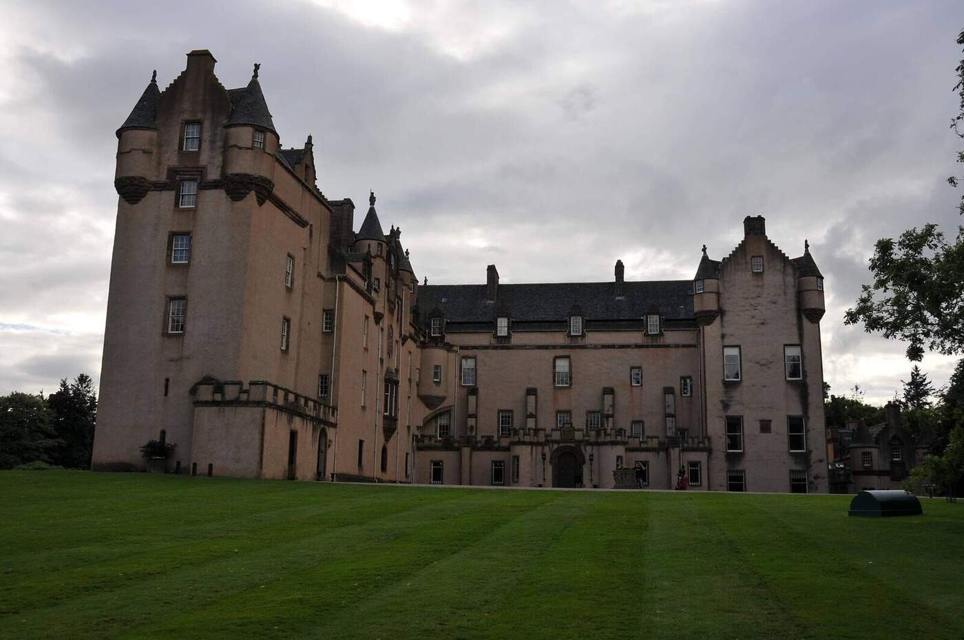Fyvie Castle towers and long wing beside the lawn