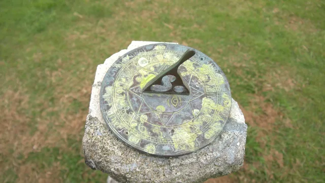 Close view of the weathered sundial face at Glengorm Castle