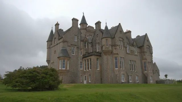 Glengorm Castle corner turrets and bay windows above the lawn