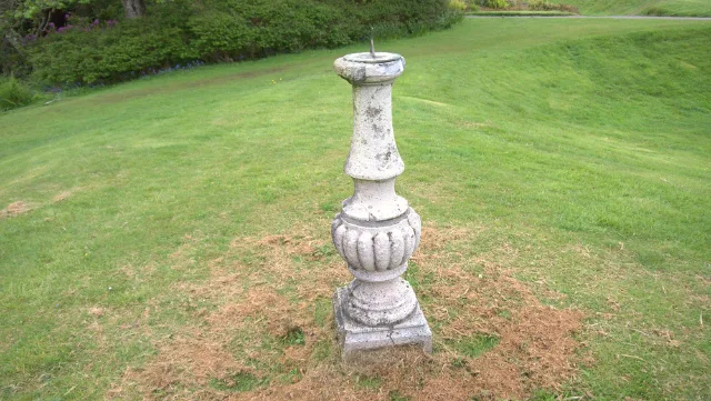 Stone sundial pedestal on the lawn at Glengorm Castle
