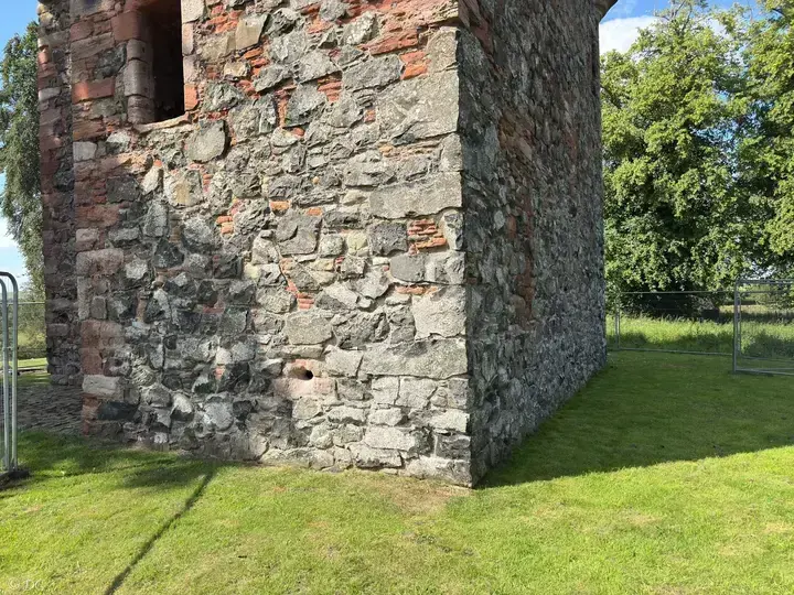 Close view of Greenknowe Tower stonework and red window surround