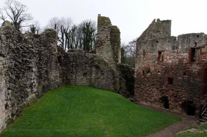Hailes Castle's grassy courtyard enclosed by ruined stone walls
