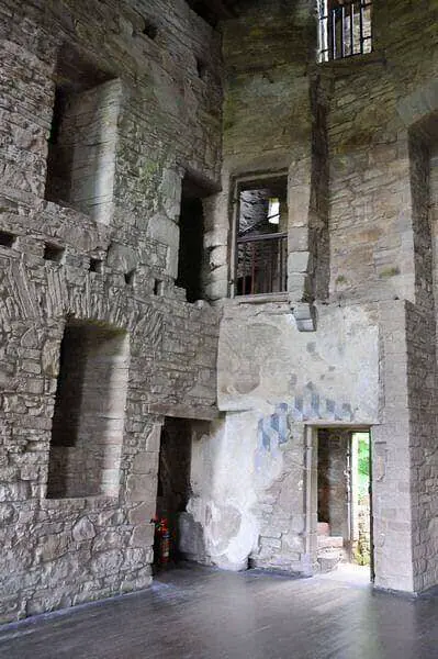 Stone interior with empty windows and traces of plaster at Huntingtower Castle