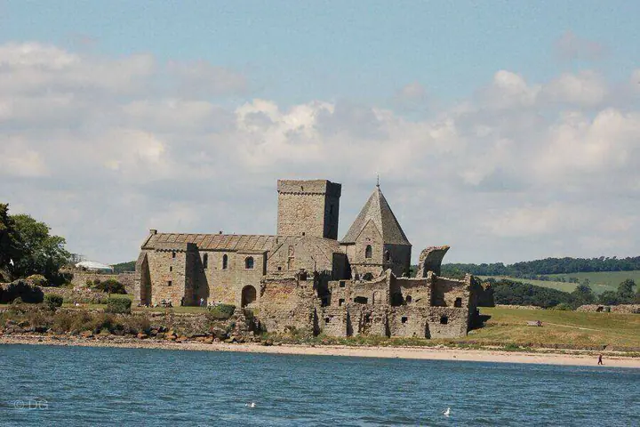 Inchcolm Abbey's towers and ruins seen across the water