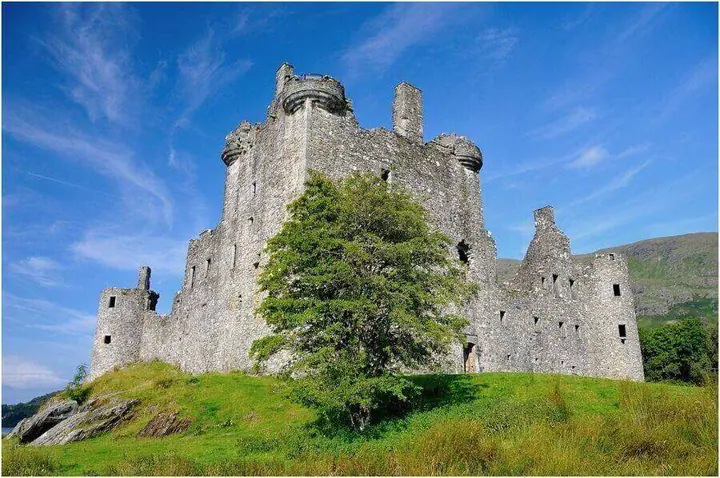 Kilchurn Castle tower partly screened by a leafy tree