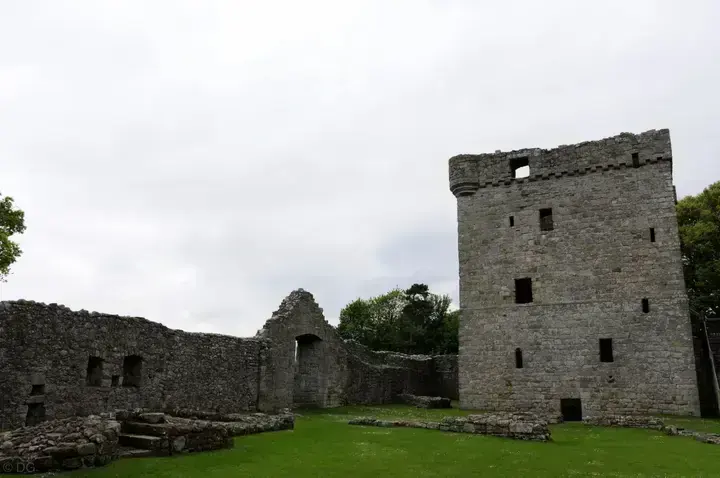 Loch Leven Castle tower and roofless walls around a grass courtyard