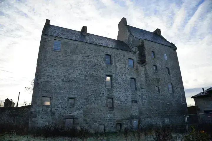 Rear wall of Midhope Castle with rows of windows and slate roofs