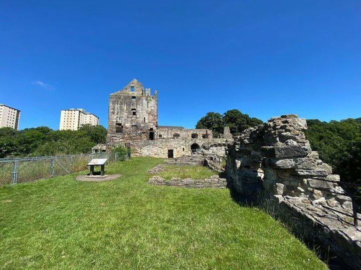 Ravenscraig Castle's grassy courtyard with low ruins in the foreground