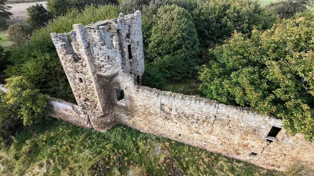 Saltcoats Castle's roofless tower and adjoining wall seen from above