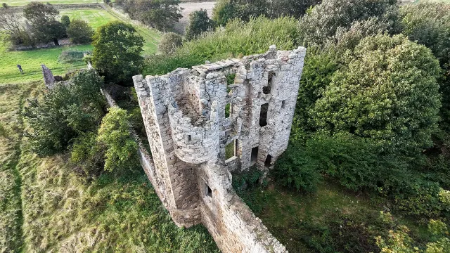 Looking into Saltcoats Castle's ruined tower above ivy-covered walls