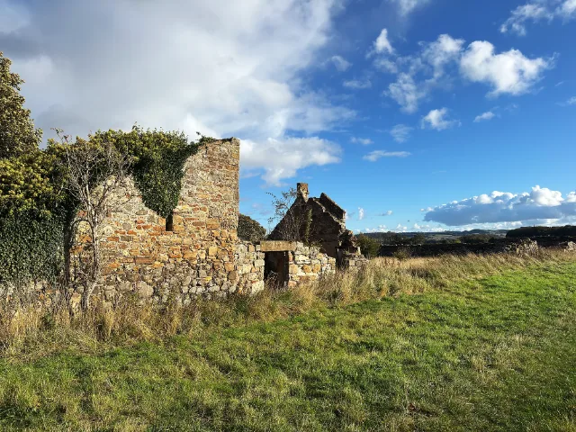 Low roofless buildings and a small doorway in Saltcoats Castle's ruins
