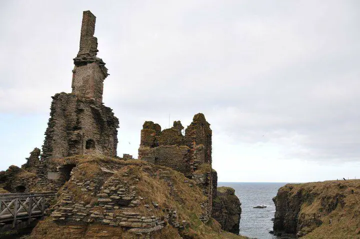 Sinclair Girnigoe Castle chimney and tower ruins beside a deep coastal cleft