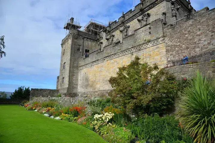 Stirling Castle facade above colourful garden flower beds