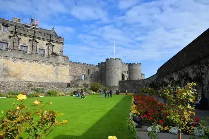 Flower-lined lawn leading towards the round towers of Stirling Castle
