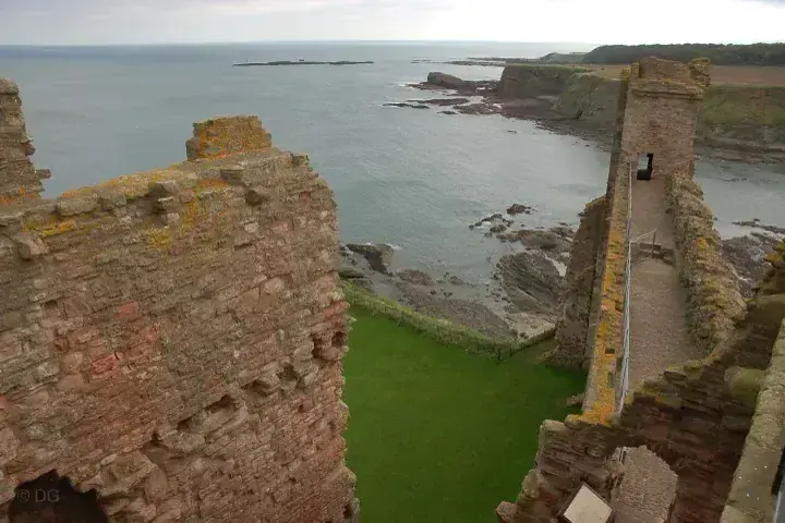 Tantallon Castle walls and a narrow standing tower overlooking the coast