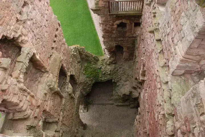 View down between Tantallon Castle stone walls towards a doorway