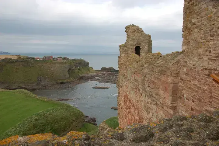 Tantallon Castle red stone wall above a sheltered rocky bay